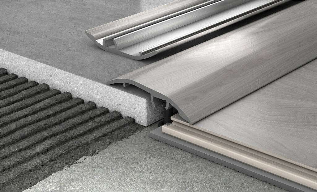 Metal threshold strip on a concrete floor