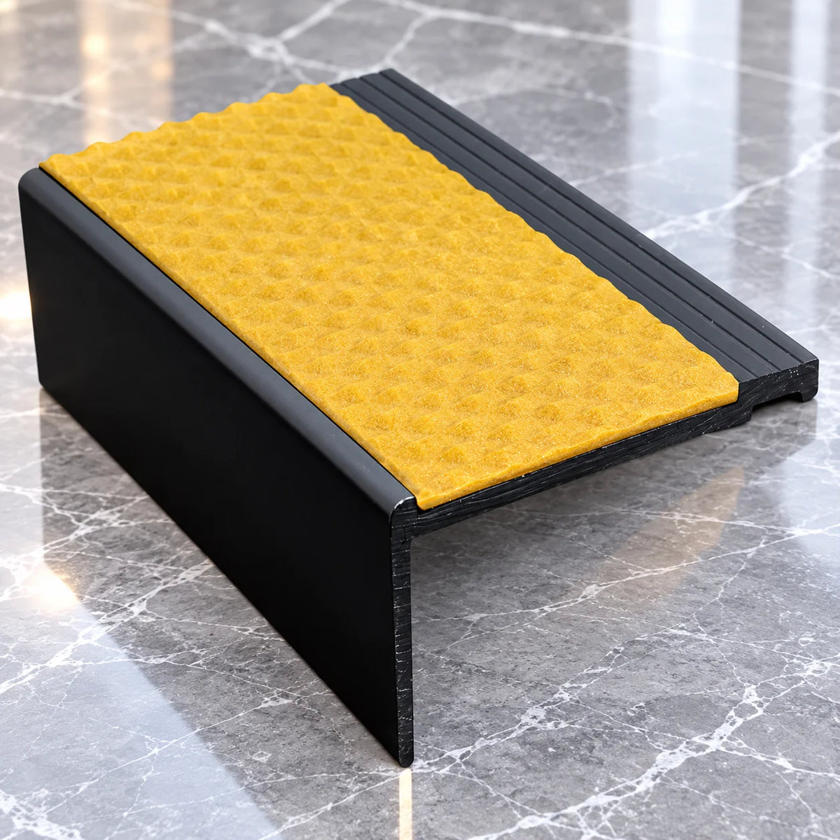 Durable 60.4 x 32mm heavy duty PVC stair nosing featuring a slip-resistant tread surface for improved grip and stair safety.