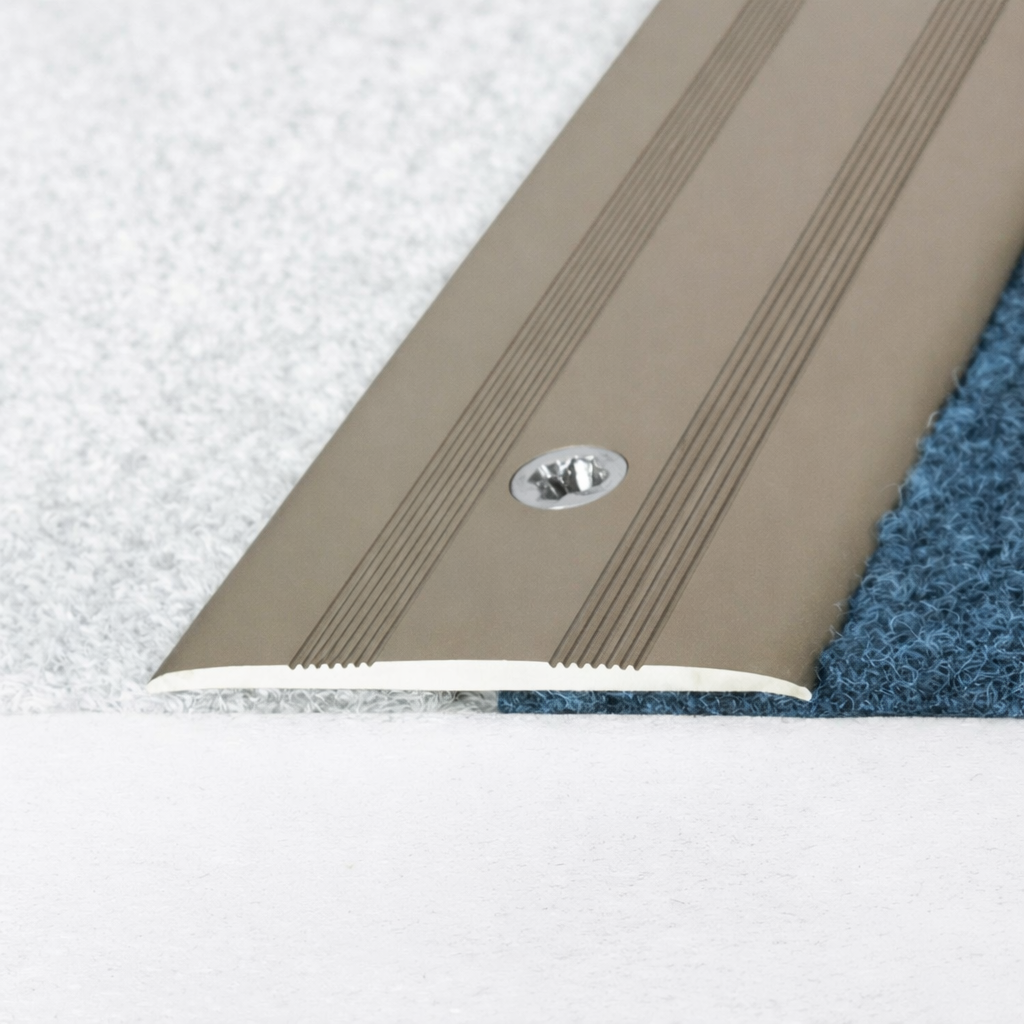 A08 35mm anodised aluminium flat door threshold profile installed at a doorway, covering the joint between two different floor finishes for a seamless transition.
