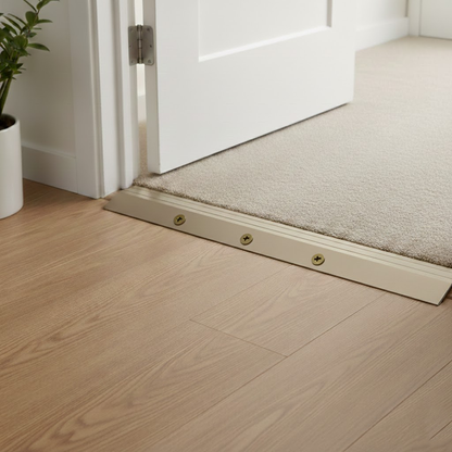 Usage of a 40mm anodised aluminium ramp door threshold profile creating a safe transition between uneven floors.