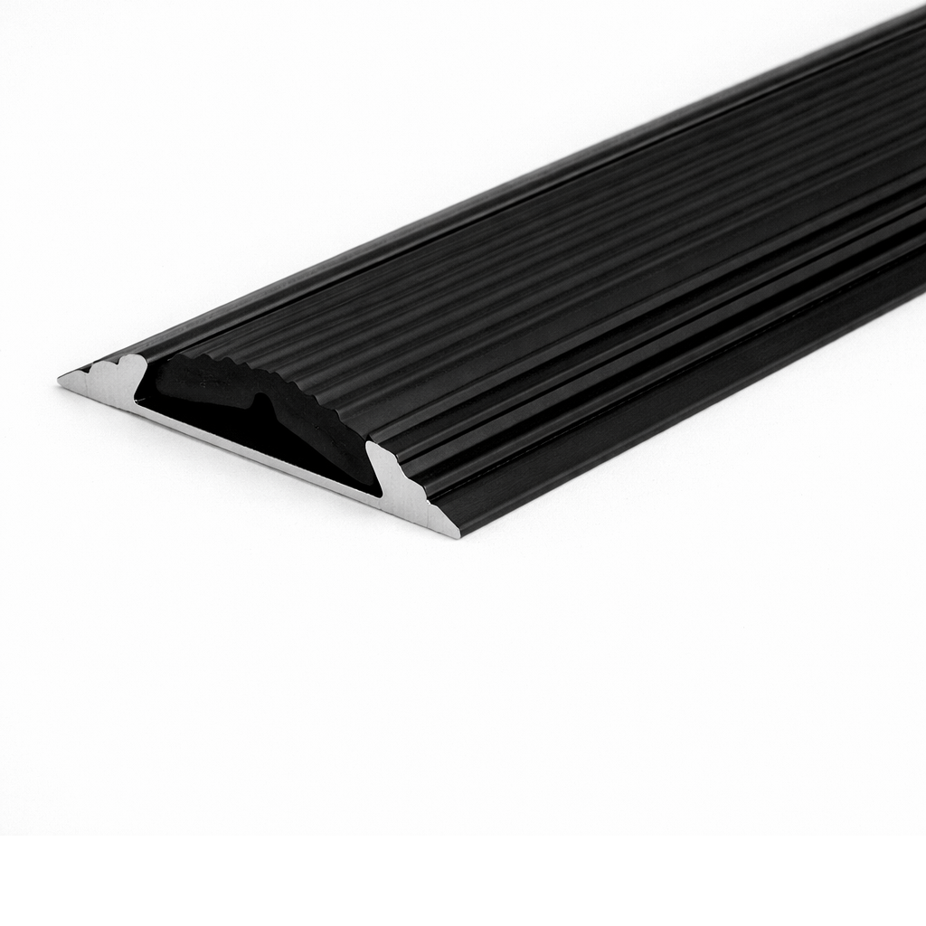 Black A10 anodised aluminium flat non-slip threshold strip installed between two floor surfaces for added safety.