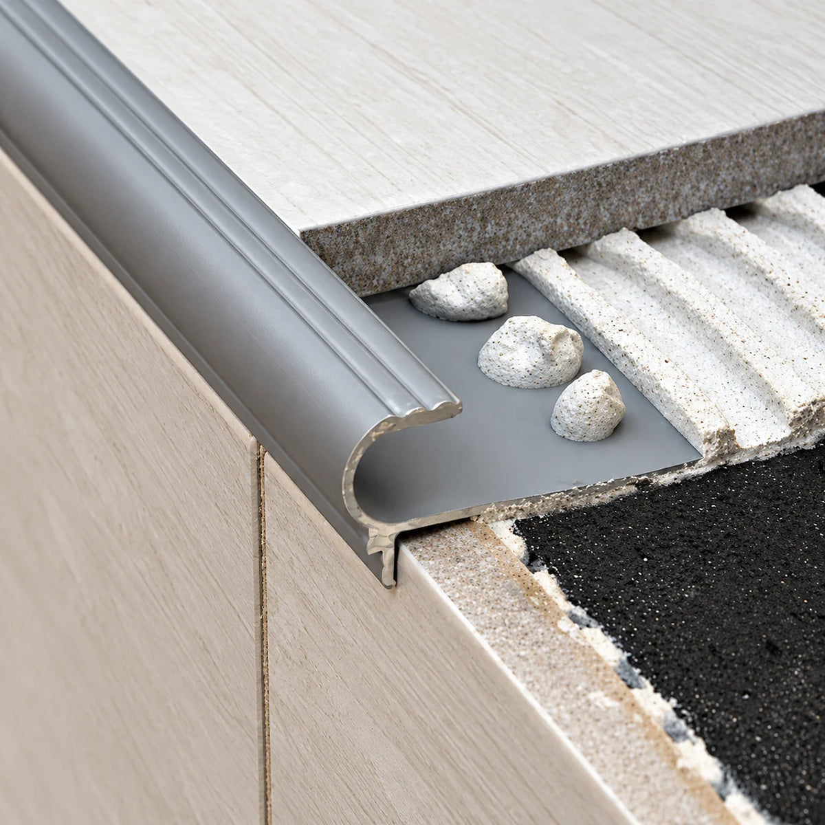 Premium aluminium tile-in stair nosing designed for 10mm and 12mm floor tiles, providing a neat finish and long-lasting protection for tiled stair edges.