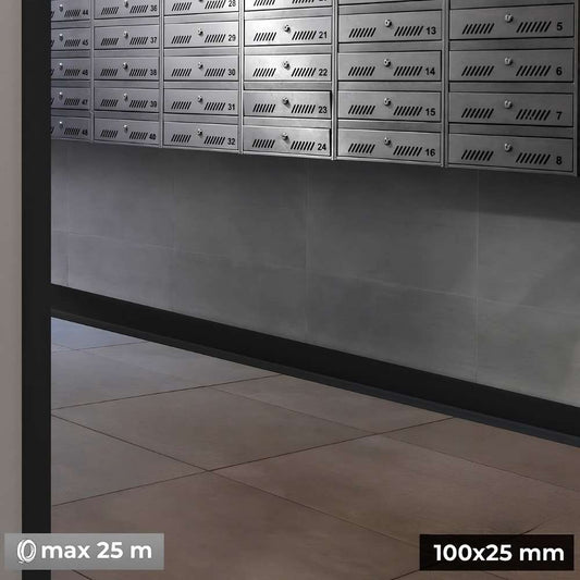 Row of metallic mailboxes with numbers on a tiled floor.
